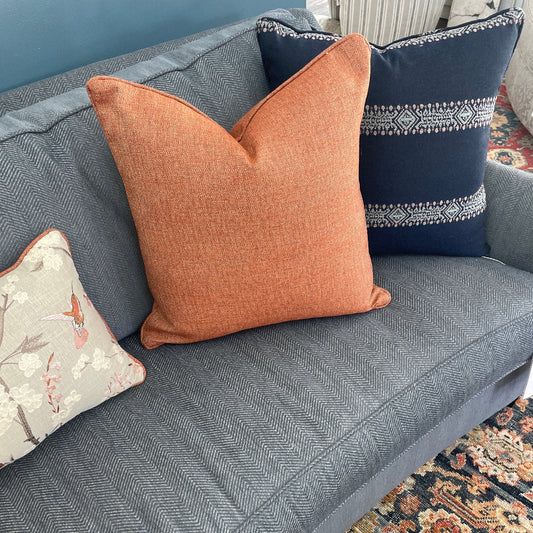 Rust Pillow on Blue Sofa