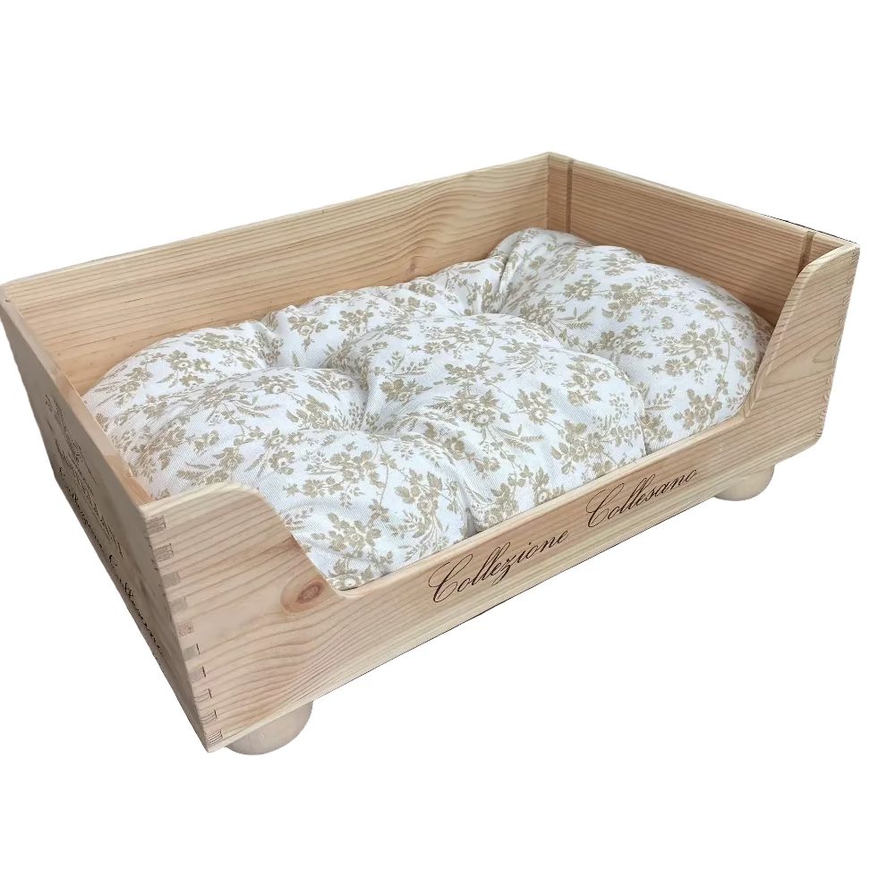 Wooden pet bed with floral cushion on a wooden floor